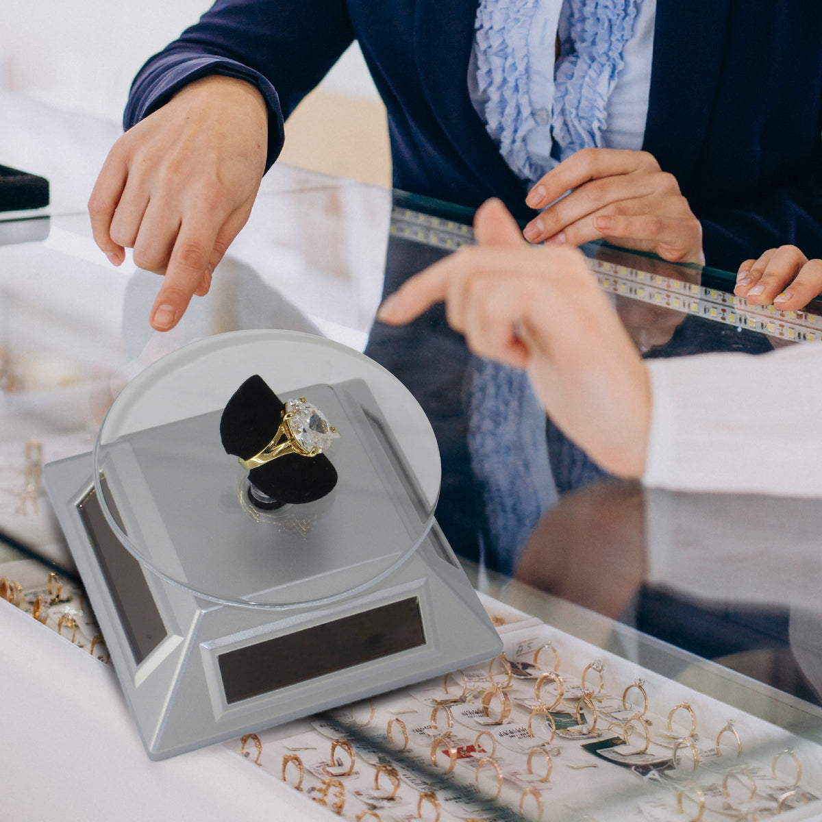 Solar-powered display plate for loose diamonds and luxury jewelry