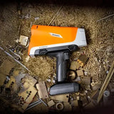 Handheld XRF analyzer testing gold coins and bullion